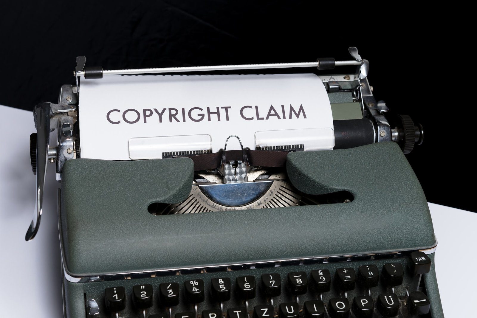 A typewriter with a sheet of paper reading Copyright Claim